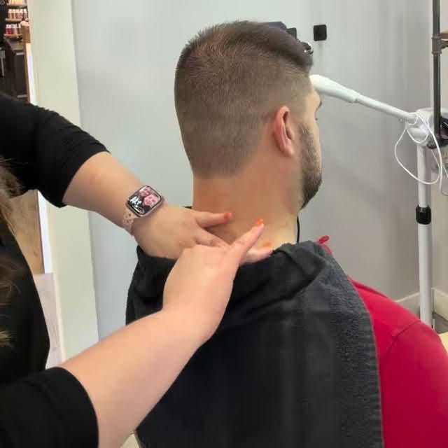 Kait giving a client a neck and shoulder massage
